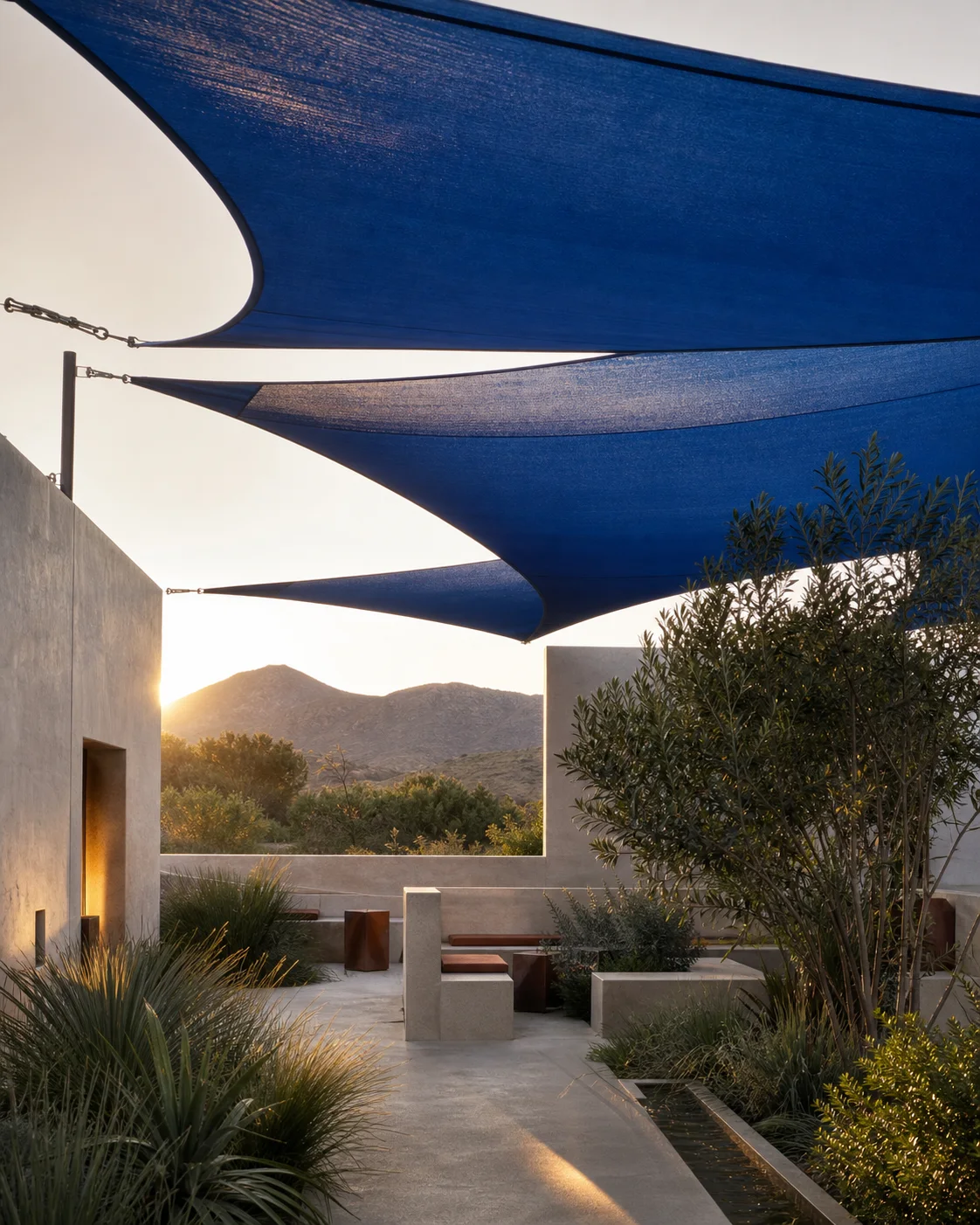 Cobalt knitted shade sails over a premium architectural courtyard